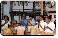 Photograph of blind people making baggage tags